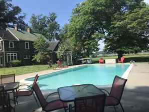 The swimming pool is a gathering place for family fun and dining by the water.