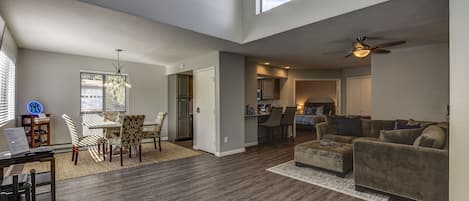 Living Room/Dining Area with vaulted ceilings and an abundance of natural light 