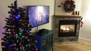 The comfy living room sports a large screen TV.