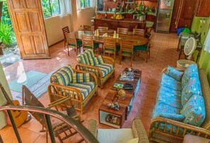 View of living and dining area from stairs. Underneath are books and games.