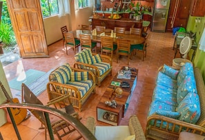 View of living and dining area from stairs. Underneath are books and games.