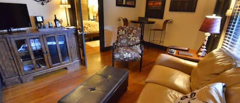 Living area includes leather sleeper sofa, mini fridge, DVD player and Wi-Fi