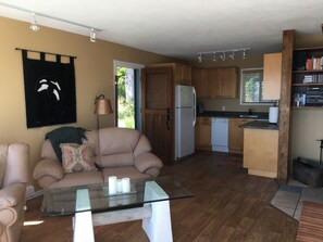 Living room with fully equipped kitchen.