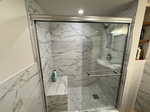 Tiled, walk-in shower with bench