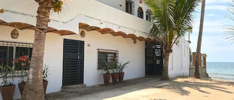 The front of La Esquina Perezosa with our new landscaping and beach access.