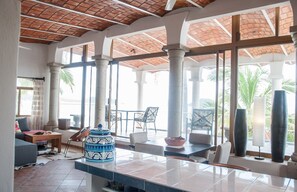 Large, expansive main living area with panoramic floor to ceiling windows that o