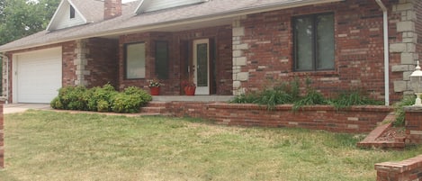 Front of house with double car garage. House is much larger than it appears.