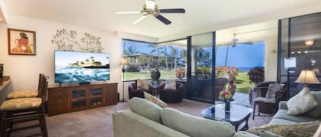 Livingroom with expansive view of the ocean and gardens.
