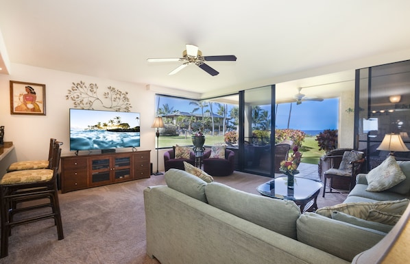 Livingroom with expansive view of the ocean and gardens.
