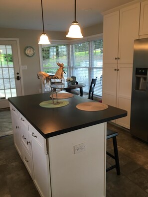 Island has 2 stools, and the corner table also seats 2 