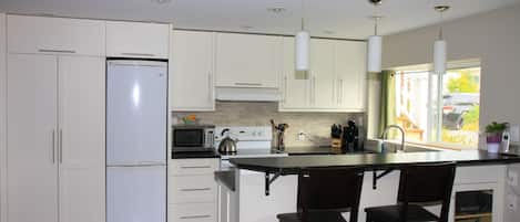 Custom kitchen with bar seating for up to 4.