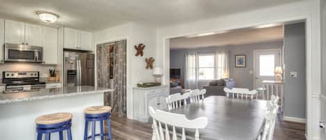 Enter through the porch into dining/kitchen area