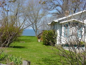 Front of the house, side yard and lake as seen from the parking area.