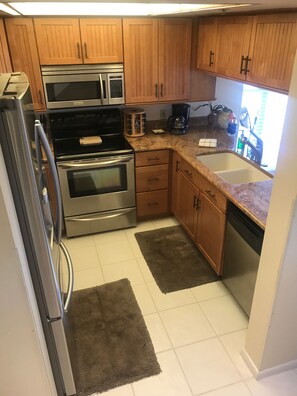 Remodeled kitchen with hardwood cabinets granite countertops and new appliances