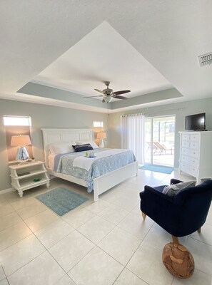 Spacious and comfortable king master with private pool access and view.