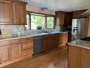 New kitchen cabinets, granite counters, refrigerator, exhaust, finished floor 