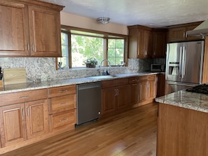 New kitchen cabinets, granite counters, refrigerator, exhaust, finished floor