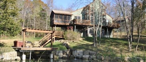 View from back of the property looking at house and pond.