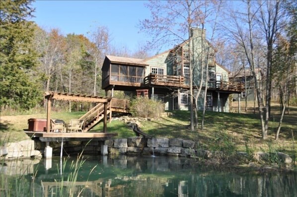 View from back of the property looking at house and pond.