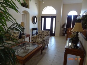 The foyer is spacious giving way to cathedral ceilings