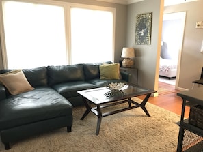 view of living room to front door and guest bedroom