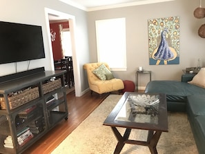  View of Living room from guest bedroom with Uverse TV and surround sound.