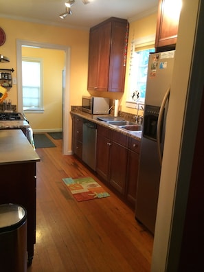 Kitchen looking to laundry room from dining area