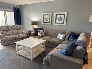 Plenty of seating with sectional and double recliner in living room. 