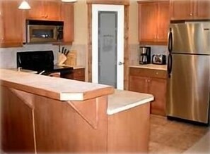 Kitchen with heated tile floors (sink is on the island, out of view).