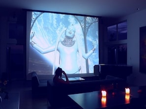 The 14' x 10' movie screen lowered in the living room...