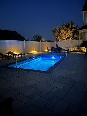 Pool and patio night time view  

