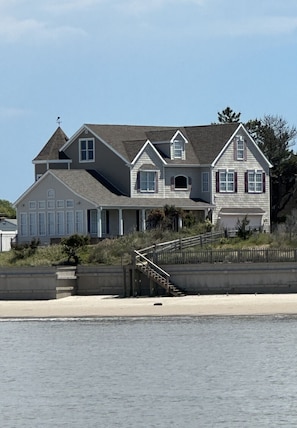 View of house from the water,  showing steps to beach 