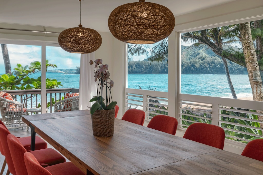 Dining area of a vacation rental in Hawaii overlooking a bay