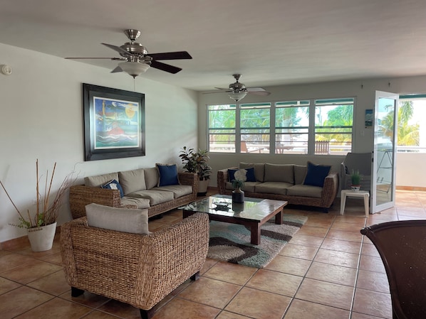 Spacious open plan living room, dinning and kitchen area, with balcony.