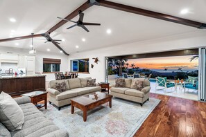 As you enter, you'll be greeted by the open floor plan with 12-14ft vaulted ceilings, a modern updated design, and beautiful hardwood floors with natural travertine stone throughout the home