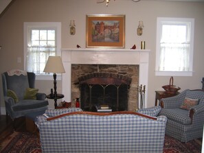 Historic fireplace graces the comfortable pond suite living room.