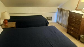 The upstairs bedroom has a full and a twin