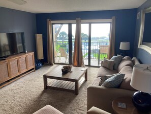 Living area with pull out sofa bed and balcony overlooking Atlantic Ocean.