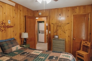 South bedroom.  Queen bed.  TV, Closet.  Dresser.  Air conditioner. Ceiling fan.