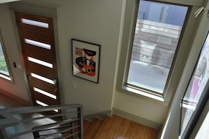 Beautiful birch modern floors and local concert posters line the stairway.