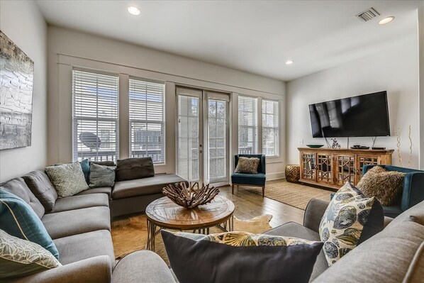 Enjoy the Flat-Screen TV & Balcony Access in this Cozy Living Area