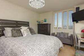 Comfortable queen bed with overhead fan