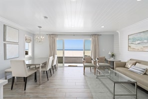 Sliding doors open from the main living area out to the front patio, boardwalk, and beach beyond!