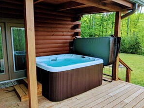 Brand New 2019: 65 jet ~ 7 person Hot Tub. Wicker bench/footstool to the left.