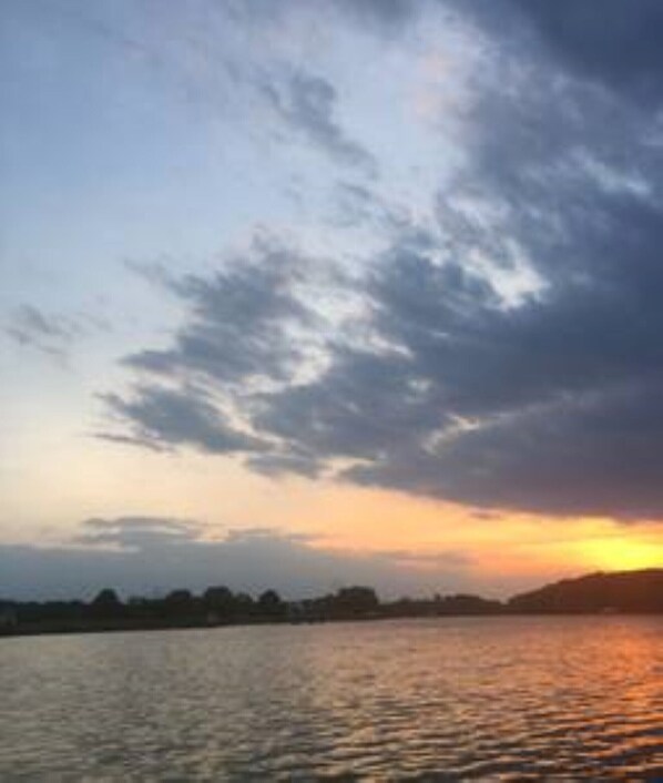 Enjoy sunsets from the back yard with private pier.