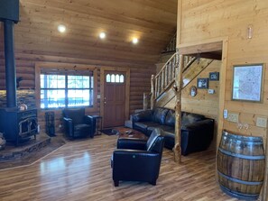 The open and light living room area includes a wood burning stove.