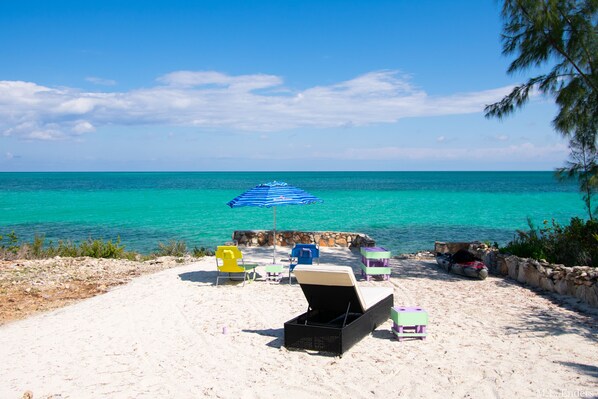 Sun yourself on our beautiful sand terrace. Use the stairs to enter the ocean.