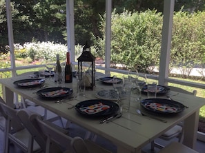 The screened back porch allows for bugless outdoor dining!

