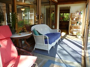 Feel the warmth on sunporch with screens and look out on the gardens and woods.