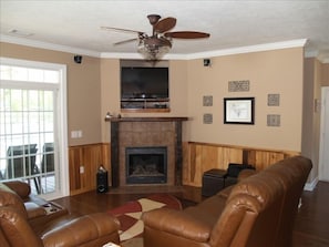 Great Room with fireplace and satellite HDTV, sliding doors to lakeside.